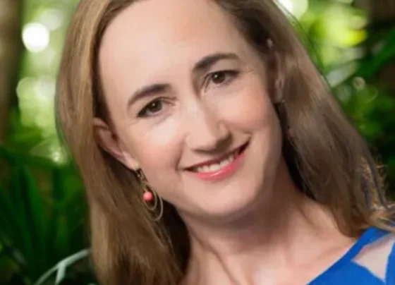 Tribute illustration of Sophie Kinsella, the bestselling Shopaholic author, with books around her.